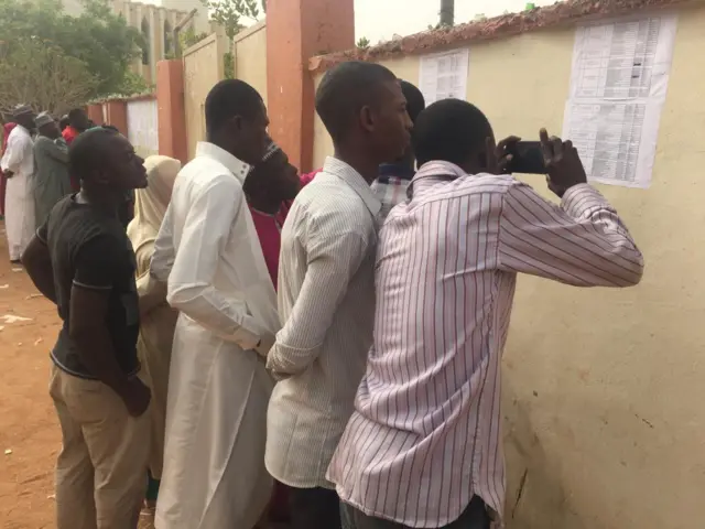 People taking a picture of the voters' register