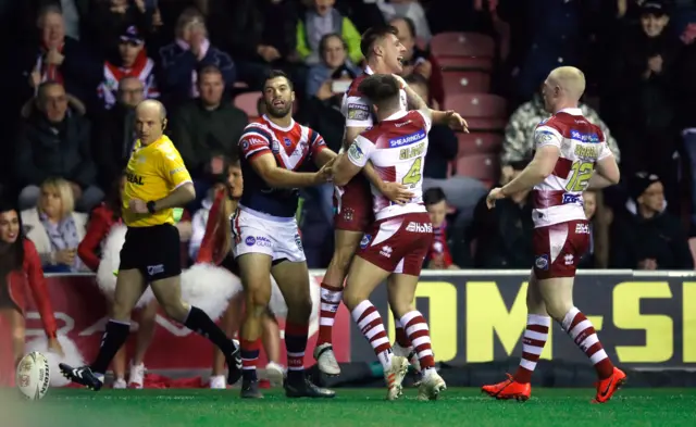 Wigan celebrate their first try against Sydney Roosters