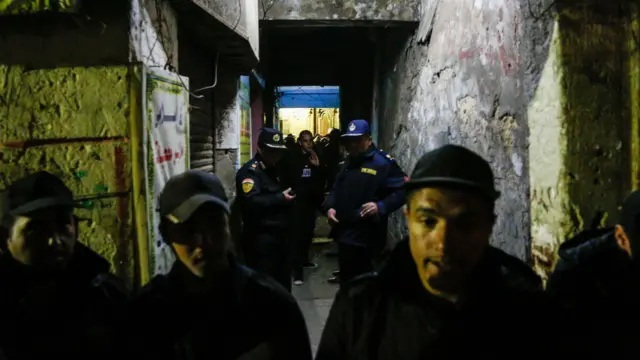 Police officers in the alleyway where the bombing happened