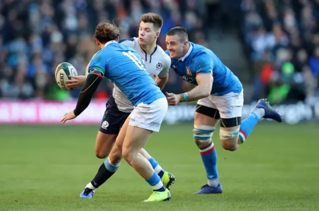 Huw Jones attempts an offload