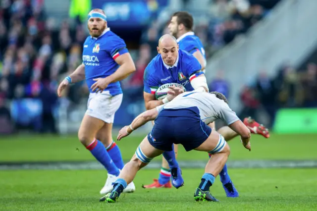Sergio Parisse is tackled by a Scotland player