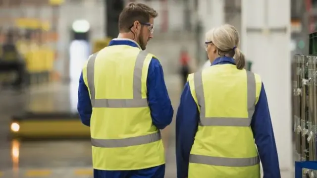 man and woman in yellow vest