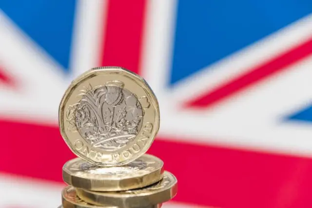 pound coins and union jack flag