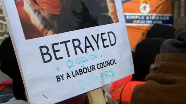 Picket sign reading "betrayed again by a Labour council"