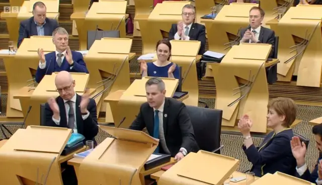 His SNP colleagues applaud as Mr Mackay takes his seat