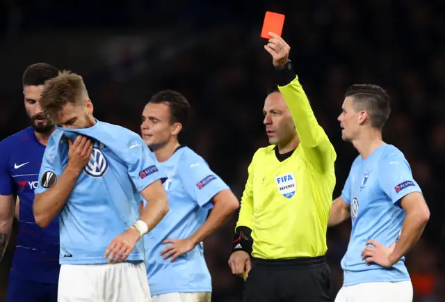 Rasmus Bengtsson of Malmo is shown a red card