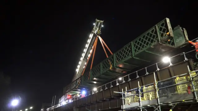 The footbridge being lifted