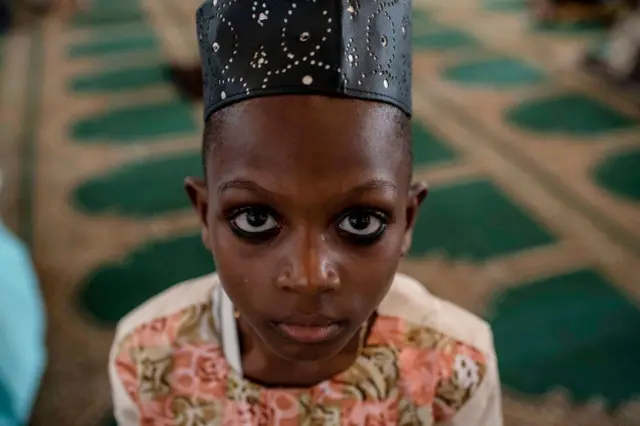 Boy praying in a mosque