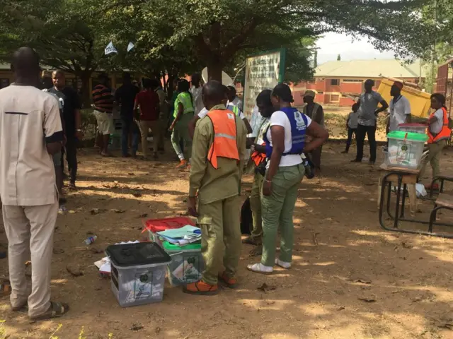 People looking at ballot boxes