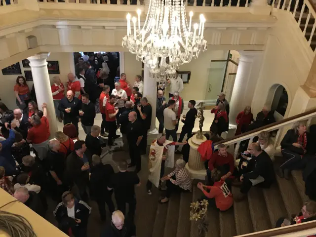 A hotel lobby full of rugby fans