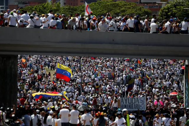 Supporters of Juan Guaidó take part in a rally in Caracas to demand President Nicolás Maduro allows humanitarian aid to enter the country