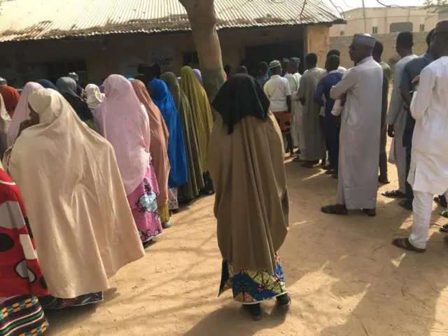 People queuing to vote