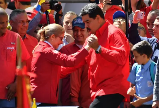 Venezuelan President Nicolas Maduro dances with his wife Cilia Flores in Caracas