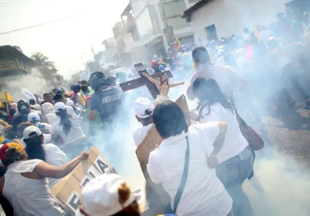 Protesters demonstrate as tear gas is used to disperse the crowds