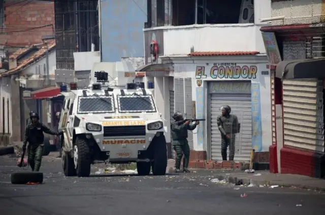 Venezuelan security forces take position while clashing with demonstrators in Urena, Venezuela