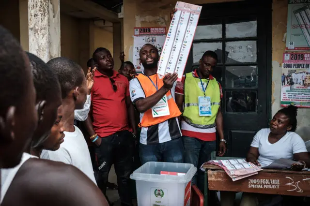 Officials count votes in front of voters during the presidential and parliamentary elections on February 23, 2019, at a polling station in Port Harcourt, southern Nigeria.