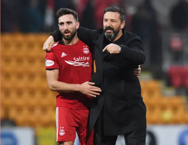 Graeme Shinnie is congratulates by Derek McInnes