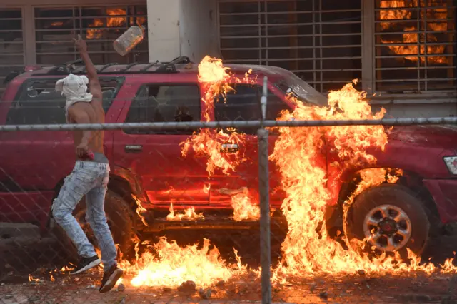 A vehicle is set alight in Pacaraima, Brazil, near the border with Venezuela