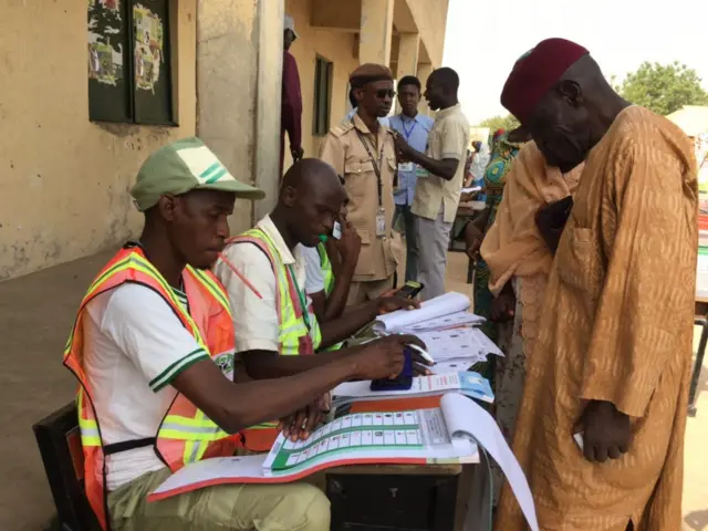 People receiving ballot papers