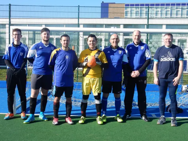 FA People's Cup Male team photo standing in front of a goal post