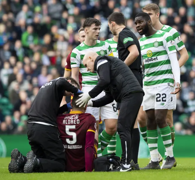 Tom Aldred receives treatment on an injury