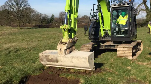 Digger moving soil