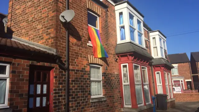 Rainbow flag at a window