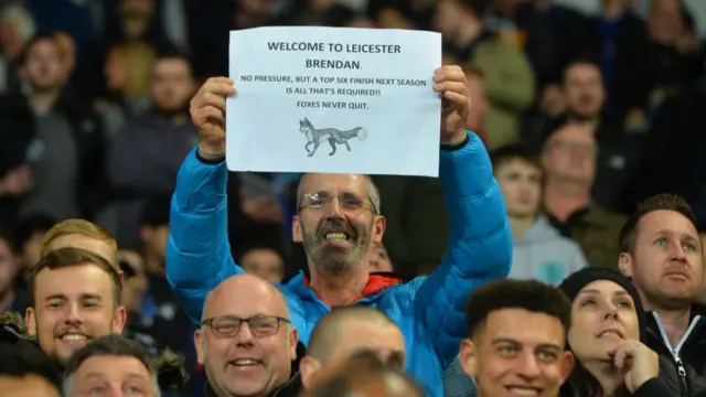 Leicester City fan with a sign