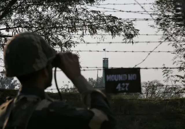 An Indian soldier patrols along the fenced border with Pakistan. File photo