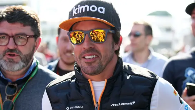 Fernando Alonso visits the McLaren paddock during F1 testing in Barcelona