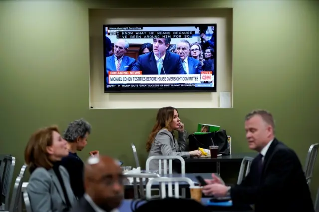 Congressional staffers watch the proceedings in a Capitol Hill cafeteria