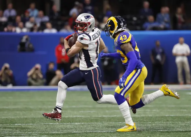 Julian Edelman runs with the football