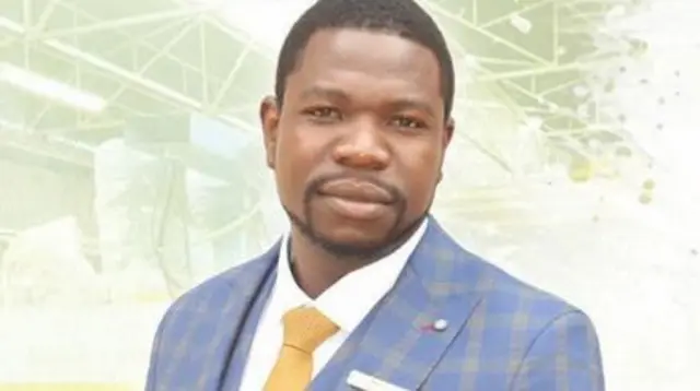 Walter Magaya wears a suit and looks square to the camera