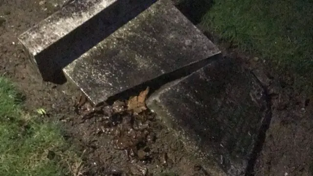 A headstone broken in half