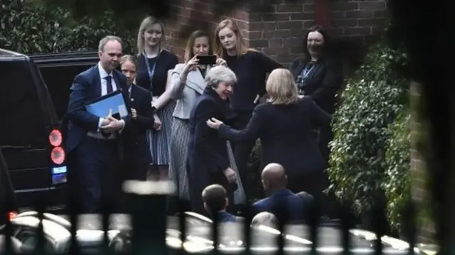 Theresa May is greeted as she arrives for talks at Stormont with Northern Ireland's main political parties