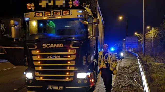 Police officer by the lorry