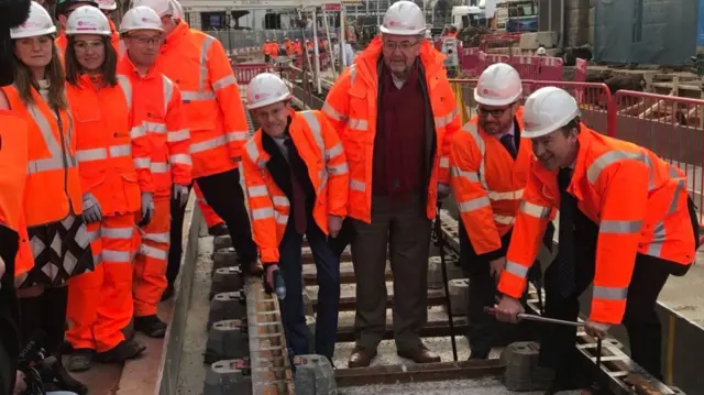 Various dignitaries symbolically laying track today