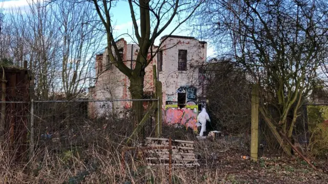 Forensics officer by abandoned building