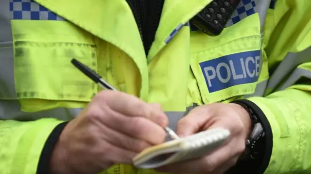 police officer using notebook