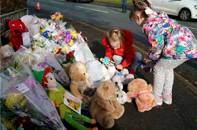 Toys and flowers at the scene