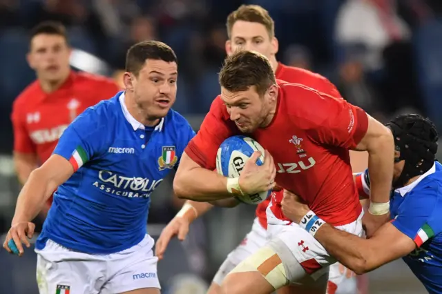 Italy's fly half Ian McKinley (R) tackles Wales' centre Owen Watkin