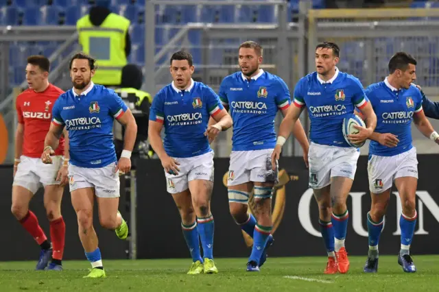 Italy's players celebrate after scoring a try