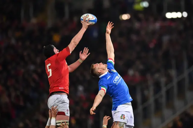 Wales' lock Adam Beard (L) and Italy's flanker David Sisi jump for the ball