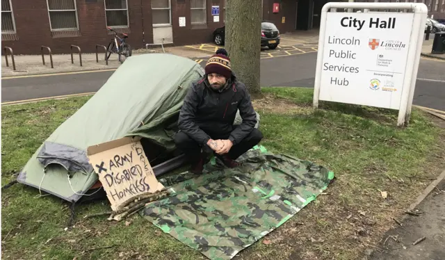 homeless man and tent