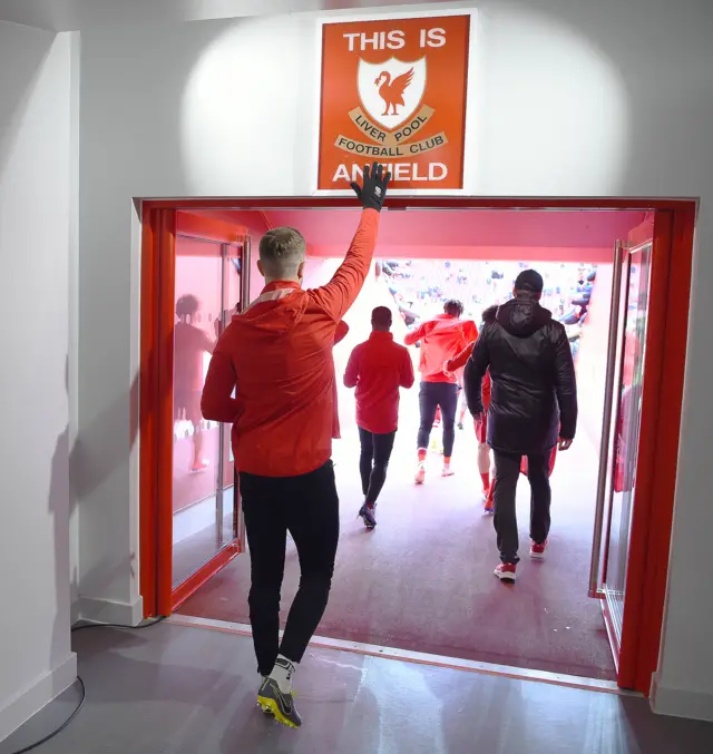 Players walk out of the tunnel