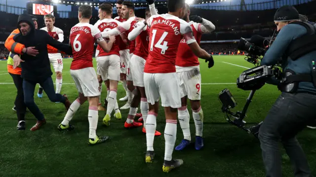 A spectator joins in with the Arsenal celebration