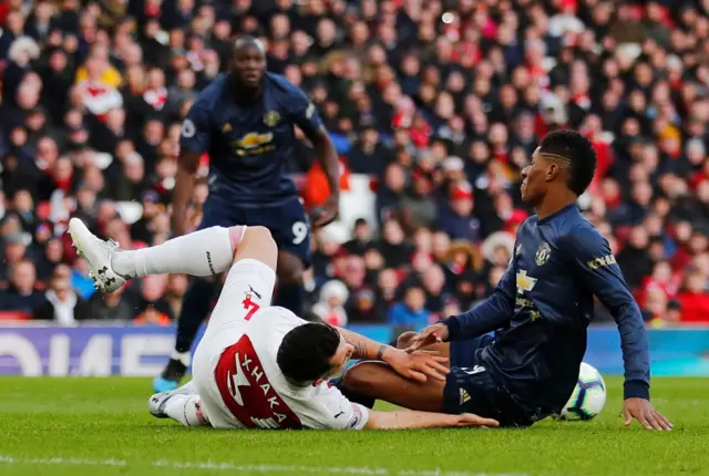 Granit Xhaka and Marcus Rashford collide