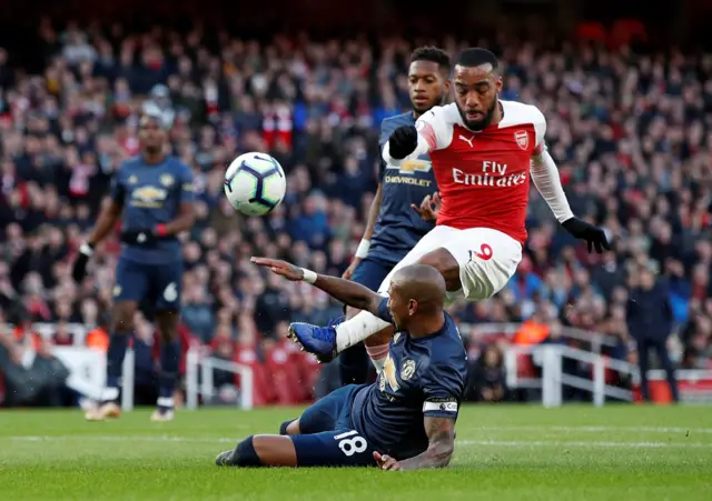 Ashley Young blocks Alexandre Lacazette's shot