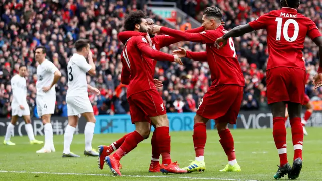 Roberto Firmino celebrates with Mo Salah