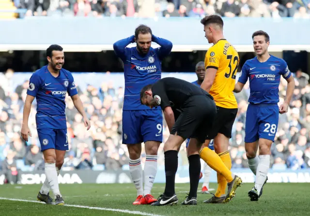 Chelsea"s Gonzalo Higuain reacts after referee Michael Oliver gestures to where an incident occurred